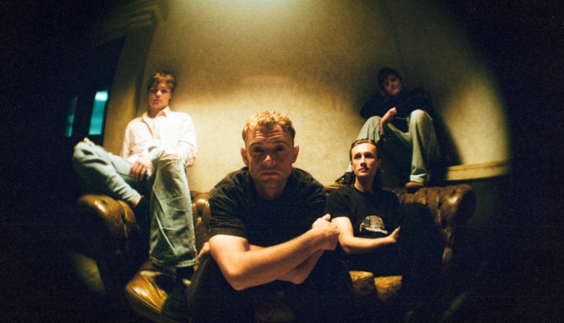 Group Wunderhorse sitting on a sofa in dimly lit room 