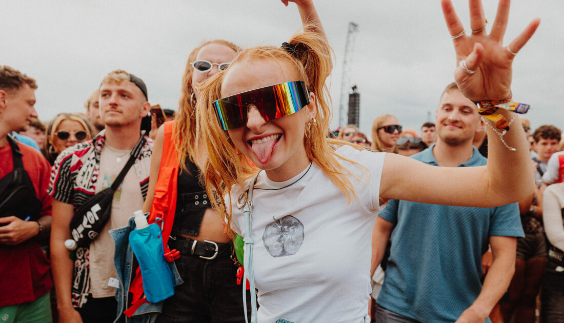 Fan smiling while wearing reflective glasses at Reading Festival 
