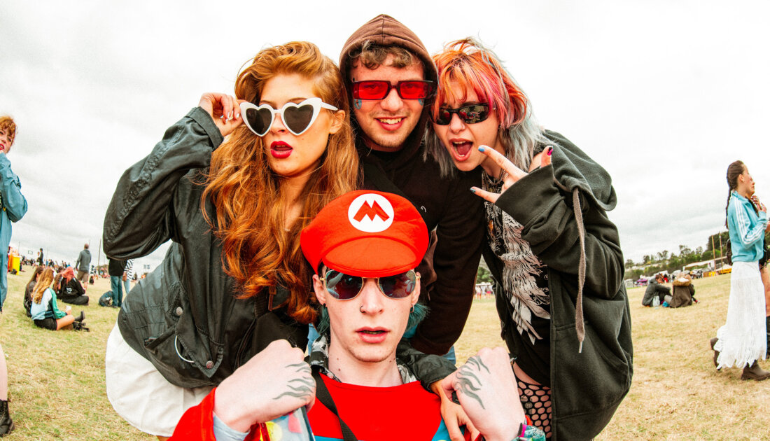 4 fans pose for photo wearing various types of sunglasses at Reading Festival