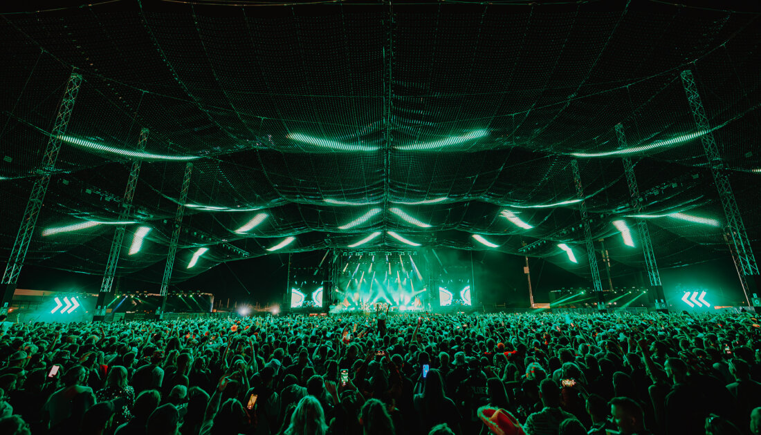 Fans under the green LED lights of the Chevron Stage at Reading Festival