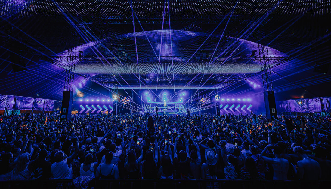 Crowds under the blue LED lights of the Chevron Stage canopy at Reading Festival 