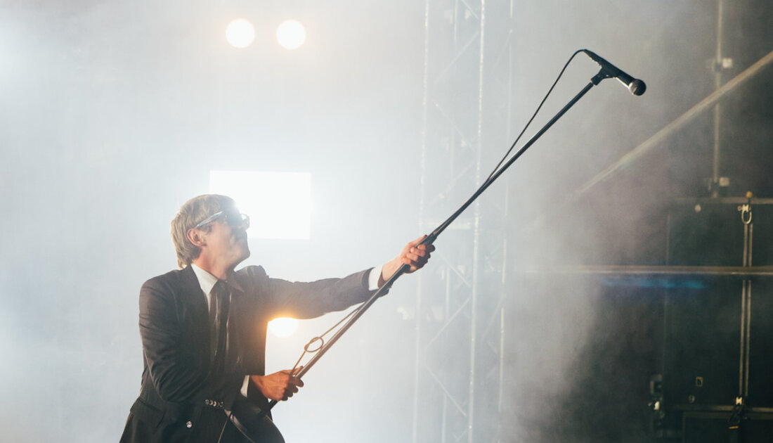 The Dare holding a microphone over the crowd as they sing along at Reading Festival