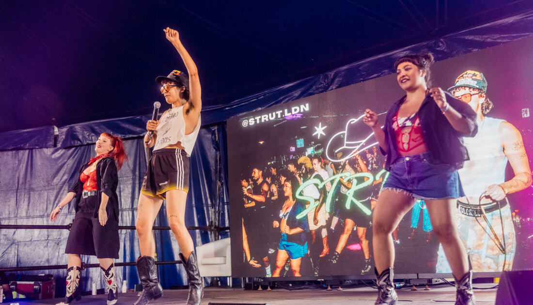 STRUT Line Dancing group on stage at Reading Festival 